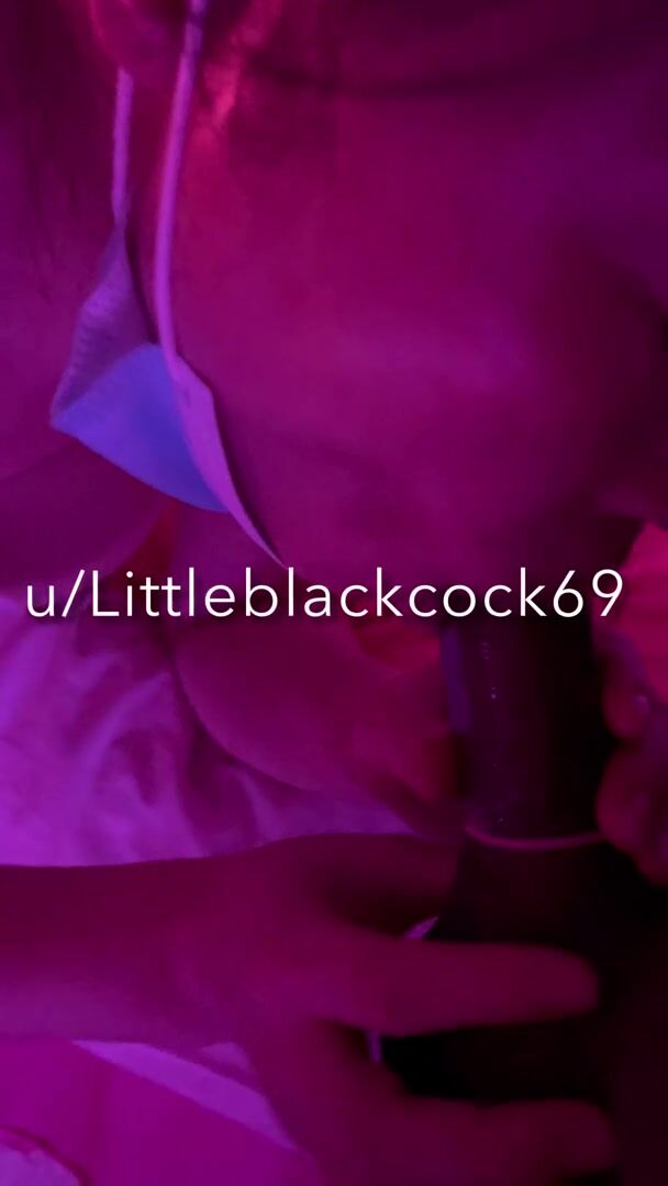 Asian beauty sucking on black lollipop